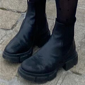 Black Chelsea boots with silver stripe on the back